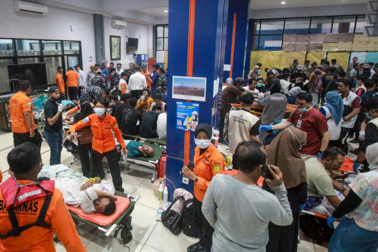 Rescue teams prepare to evacuate victims of the Virgo Transport 8 passenger ferry, which capsized while carrying 243 people on its route to Banjarmasin from Surabaya, at the port hall before heading to a hospital in Banjarmasin, South Kalimantan on September 13, 2026. 