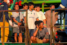 Survivors of the Virgo Transport 8 passenger ferry, which capsized September 13 carrying 213 passengers and 30 crew while en route from Banjarmasin to Surabaya, wait to disembark following their rescue at the port in Banjarmasin, South Kalimantan, on September 14, 2026. 