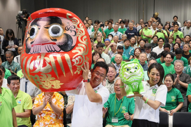 Genta Koja (front center) celebrates with his supporters after reports projected his victory in the Okinawa gubernatorial election in Naha, Okinawa prefecture on September 13, 2026. Koja won the September 13 gubernatorial election in Okinawa, Japan's southernmost prefecture, bringing into power a leader who approves a contentious US military base relocation plan for the first time in 12 years. 