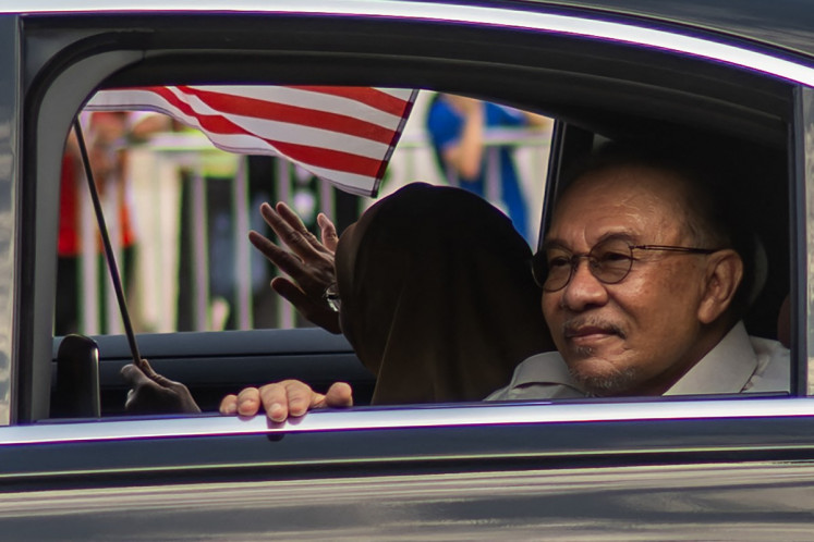 Malaysia&rsquo;s Prime Minister Anwar Ibrahim (right) and his wife Wan Azizah Wan Ismail arrive during the 69th National Day celebrations in Malaysia's administrative capital Putrajaya on Aug. 31, 2026.