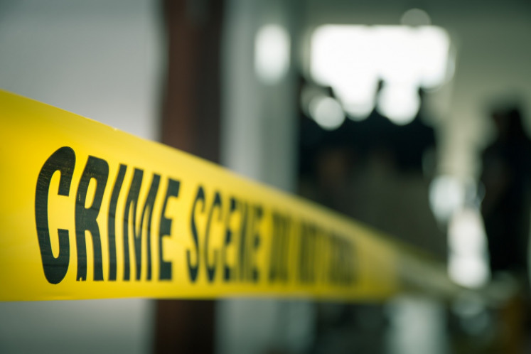 A police tape reads &ldquo;Crime scene [...]&ldquo; in this undated illustration of a crime scene. 