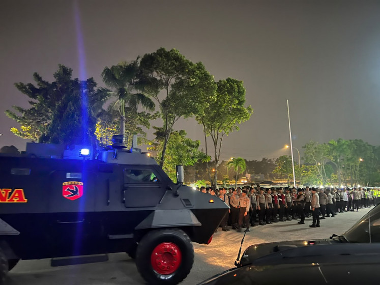 A tactical vehicle from the Mobile Brigade's Gegana Unit is on standby during a readiness roll call on Sept. 14 at Batam, Rempang and Galang (Barelang) City Police headquarters in Batam city, Riau Islands. The roll call was held following a deadly clash on Setokok Island killing two and injuring 10 people. 