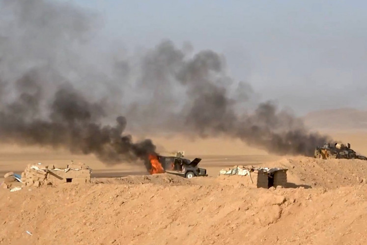 This handout picture released on September 15, 2026 by Ansarullah Media Centre reportedly shows burning military vehicles that they targeted in al-Jawf, Saudi Arabia. The Houthis have been engaged in renewed fighting with Saudi-backed government forces since Yemen's civil war reignited in July, when the group declared a maritime blockade on Riyadh and began targeting its ships in the Red Sea. 