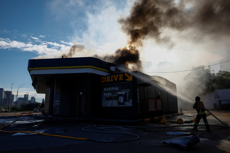 A firefighter works at the site of a gas station hit by a Russian drone strike, amid Russia's attack on Ukraine, in Kyiv, Ukraine on September 15, 2026. 