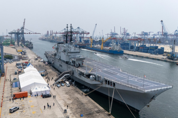 This aerial picture shows former Italian Navy aircraft carrier Giuseppe Garibaldi docked upon its arrival from Italy at Tanjung Priok port in Jakarta on September 18, 2026, ahead of its handover to the Indonesian Navy. 