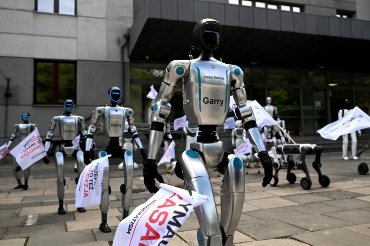 Humanoid and quadruped robots participate in a demonstration calling for the regulation of artificial intelligence on Sept. 7 in Warsaw.