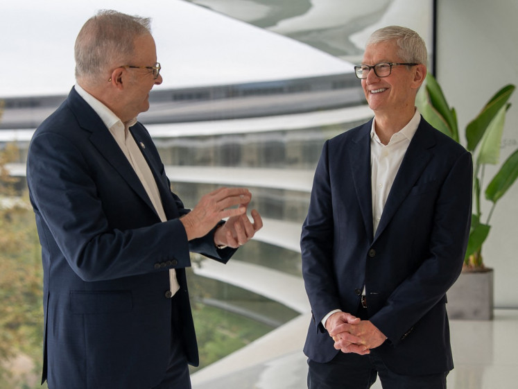 This handout photo taken on September 19, 2026 in the US Pacific Time Zone and released September 20 by the Australian Prime Minister's Office shows Prime Minister Anthony Albanese (left) meeting with former Apple CEO Tim Cook in Cupertino, California. Albanese said he was seeking big tech backing for his country's child online safety laws and greater AI regulation, after meeting Cook.