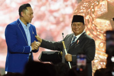 Democratic Party chairman Agus Harimurti Yudhoyono (left) hands a command stick to President Prabowo Subianto in Jakarta on Feb. 25, 2025, during the party&rsquo;s sixth congress.