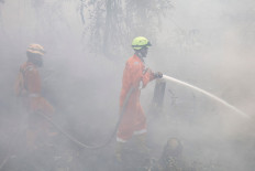 Firefighters extinguish forest and land fires in Banjar, South Kalimantan, on September 21, 2026. Toxic haze has shrouded parts of Indonesia, Malaysia and Singapore for weeks as Jakarta struggles to contain fires that have scorched large tracts of Borneo and Sumatra, with the smoke drifting across the region.