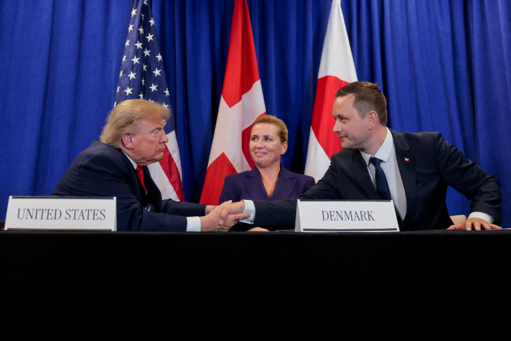 US President Donald Trump shakes hands with Greenland Prime Minister Jens-Frederik Nielsen as Danish Prime Minister Mette Frederiksen reacts, as they attend a trilateral signing event regarding a deal on Greenland's security, during the 81st United Nations General Assembly, in New York City, US, September 22, 2026.