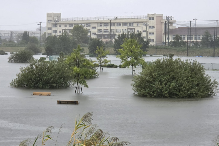 Flooding inundates a park as heavy rain falls amid weather patterns due to Typhoon Dujuan in Ichikawa city, Chiba prefecture on September 21, 2026. Typhoon Dujuan forced the cancellation of at least 275 flights in Japan on September 21 and prompted warnings of potentially record-breaking rainfall as the storm nears Tokyo.