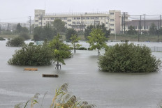Flooding inundates a park as heavy rain falls amid weather patterns due to Typhoon Dujuan in Ichikawa city, Chiba prefecture on September 21, 2026. Typhoon Dujuan forced the cancellation of at least 275 flights in Japan on September 21 and prompted warnings of potentially record-breaking rainfall as the storm nears Tokyo.