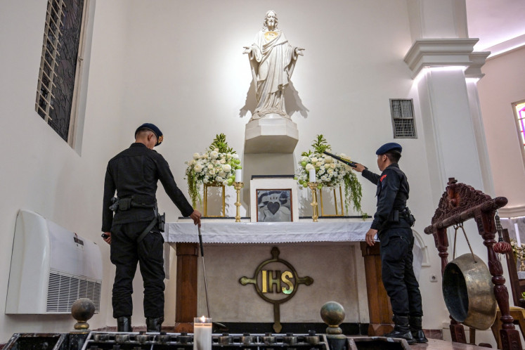 Police officers conduct a security check at the Sacred Heart of Jesus Cathedral Church, known locally as the &ldquo;Hati Kudus Yesus&ldquo; church, on Christmas Eve in Surabaya, East Java, on Dec. 24, 2025.