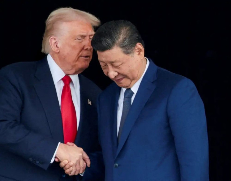 United States President Donald Trump (left) and Chinese President Xi Jinping talk on Oct. 30, 2025, as they leave after a bilateral meeting at Gimhae International Airport, on the sidelines of the Asia-Pacific Economic Cooperation (APEC) summit in Busan, South Korea. 