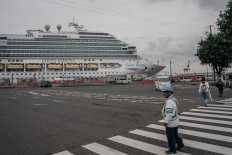 Security guards direct people near the Costa Serena cruise ship at the Port of Nagoya ahead of the 2026 Asian Games in Nagoya, Aichi prefecture on September 15, 2026. 