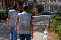 Employees walk toward the Qalandiya Vocational Training Centre run by the United Nations agency for Palestinian refugees, UNRWA, at Qalandiya in the Israeli-occupied West Bank on Aug. 4, 2026.