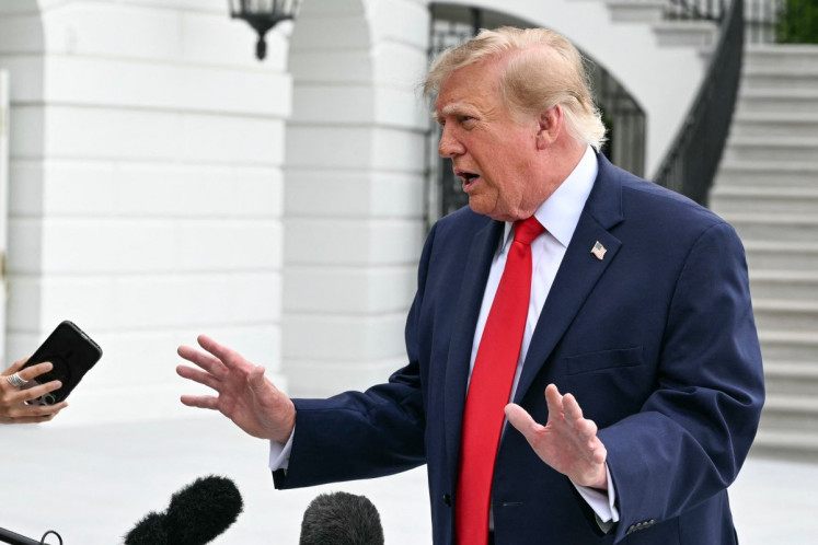US President Donald Trump speaks to members of the press before boarding Marine One as he departs from the South Lawn of the White House in Washington, DC, on September 26, 2026. Trump is heading to Knoxville, Tennessee to attend the Tennessee/Texas college football game.