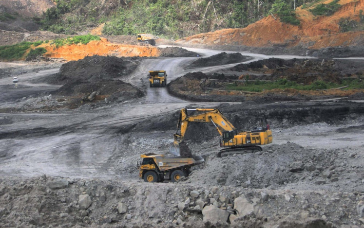 Heavy equipment owned by PT Berau Coal is used for coal mining activities at an East Kalimantan mining site, Binungan.