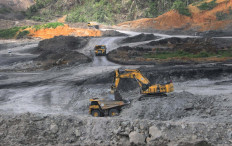 Heavy equipment owned by PT Berau Coal is used for coal mining activities at an East Kalimantan mining site, Binungan.