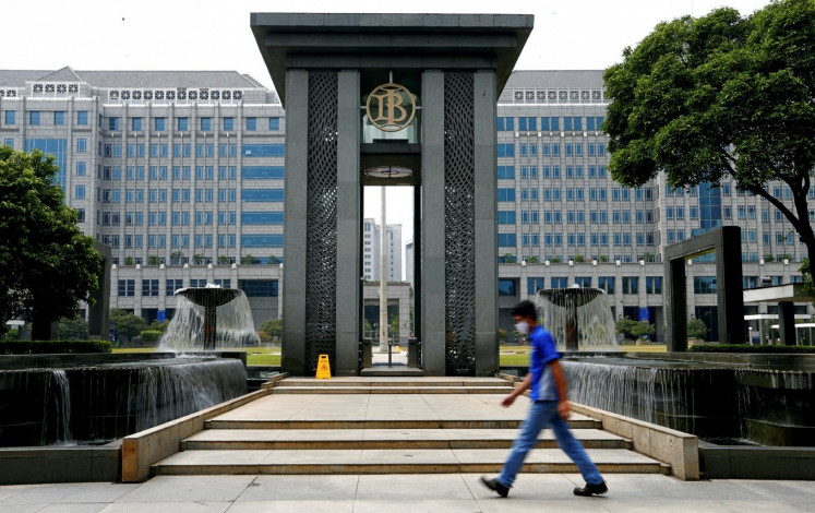 A man walks past the Bank Indonesia (BI) headquarters on Sept. 2, 2024, in Jakarta. )