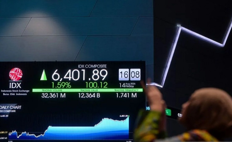 A visitor takes a photo of a screen displaying the movement of the Indonesia Stock Exchange (IDX) Composite index in Jakarta on Aug. 14, 2026.