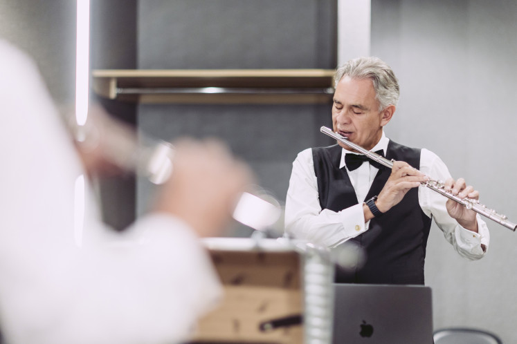 Italian tenor Andrea Bocelli, who learned to play several musical instruments from an early age, plays the flute in this undated photo.