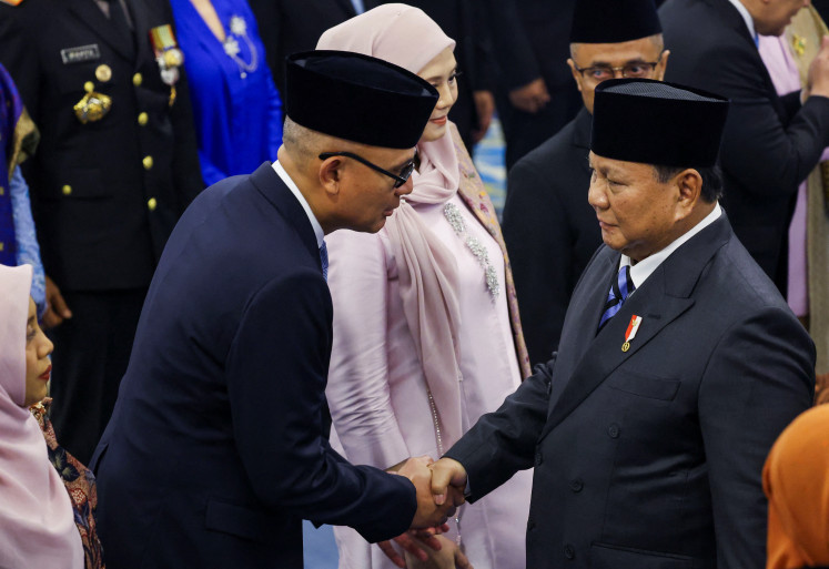 President Prabowo Subianto (right) congratulates Foreign Minister Arrmanatha Nasir on Oct. 1, 2026, following the mass inauguration of newly appointed state officials at the State Palace in Central Jakarta.