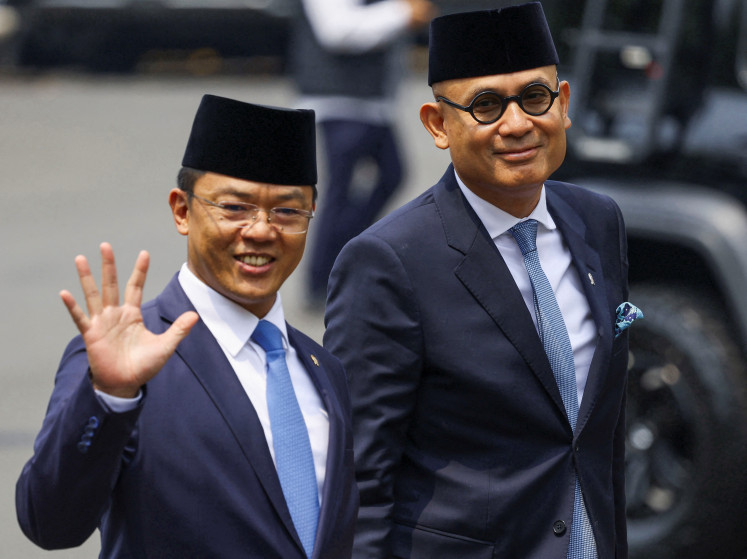 Foreign Minister Sugiono (left) gestures on Thursday as he and his deputy Arrmanatha Nasir arrive at the presidential palace for the inauguration in Jakarta.