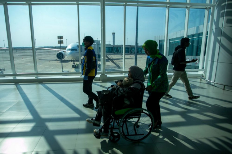 Distant landing: Airport officers assist a passenger upon her arrival at Kertajati International Airport in Majalengka, West Java, on Sept. 6, 2026, after her Garuda flight was diverted from Soekarno-Hatta International Airport in Tangerang, Banten, due to an eruption of Mount Anak Krakatau.