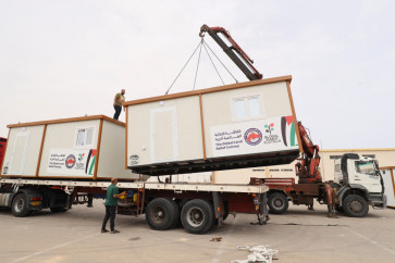 Prefabricated structures are loaded onto flatbed trucks as part of the &ldquo;Resilience 2&ldquo; land convoy as it prepares to leave for the Palestinian Gaza Strip from the staging and coordination camp in the Joud Daem forest area, about 30 km west of Tripoli, Libya on May 15, 2026.