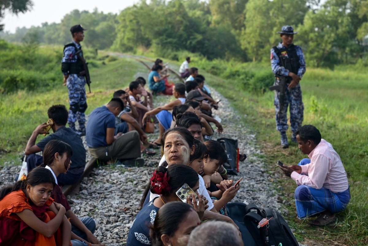 Family members wait outside the Myanmar Navy base in Thanlyin on Oct. 4, 2026 to welcome their loved ones returning from Malaysia. Nearly 1,500 Myanmar migrants from Malaysia arrived in their war-torn home country on Oct. 4, a Myanmar official said, returned under an opaque repatriation scheme that rights monitors say cannot assure their safety.