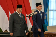 President Prabowo Subianto (left) walks past the podium ahead of a swearing-in ceremony for newly appointed cabinet ministers during a cabinet reshuffle at the State Palace in Central Jakarta on Oct 1, 2026.