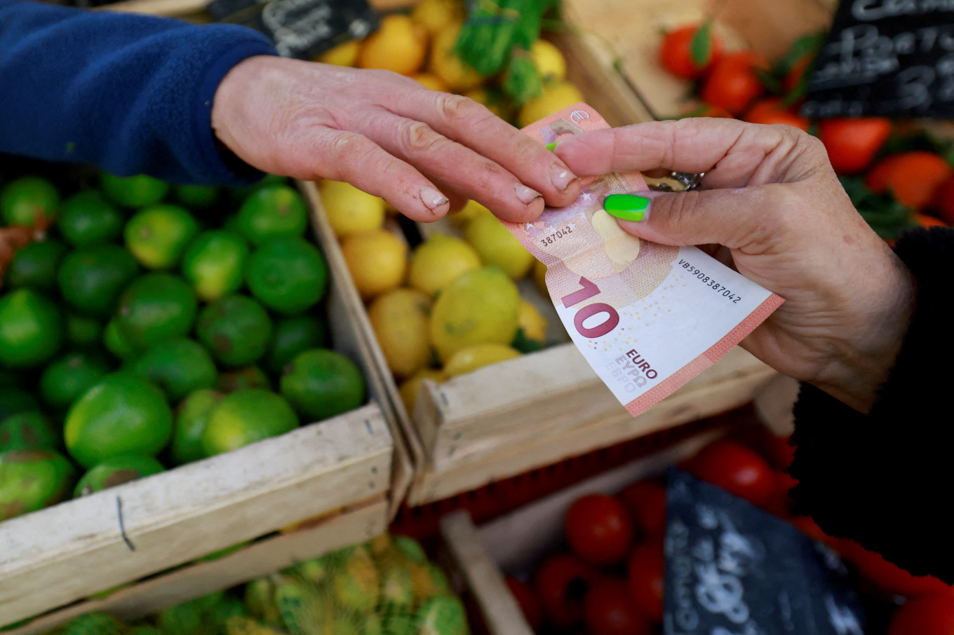 A shopper pays with a 10 euro banknote at a market in Aix-en-Provence, France, Jan. 16, 2025.