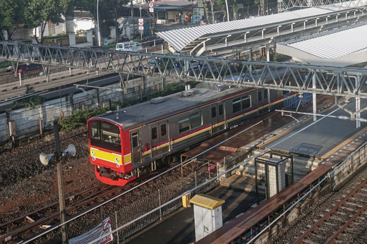 A commuter train operated by PT Kereta Commuter Indonesia, a subsidiary of state railway company PT KAI, passes Jatinegara Station on April 15 in East Jakarta. 