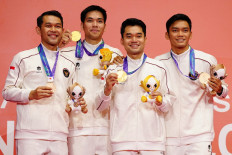 Indonesian badminton players Daniel Marthin (second left) and Leo Carnando (second right), gold medalists, pose with bronze medalists Fajar Alfian (left) and Shohibul Fikri on the podium after the men's doubles event on Sept. 29 during the 2026 Asian Games at the Ichinomiya City Municipal Gymnasium in Ichinomiya, Aichi prefecture.