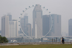 The Singapore Flyer and commercial buildings are shrouded in haze at the Marina Bay area in Singapore, on Sept. 15, 2026. 
