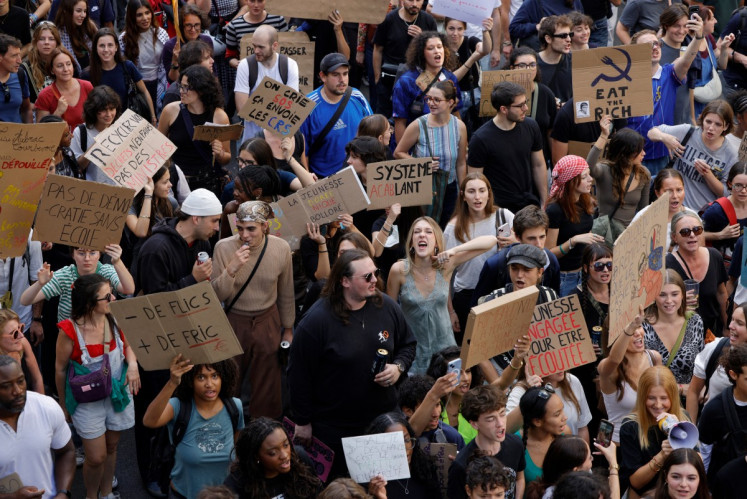 People take part in a demonstration part of a nationwide day of actions called by high-school students, joined by unions and teachers, who for days have been demanding better learning conditions in protests punctuated by violent confrontations in Paris on October 6, 2026. Students have blocked the entrances to hundreds of high schools for 15- to 17-year-olds since late September, complaining of missing teachers, overloaded timetables, dilapidated classrooms and buildings that cannot cope with rising temperatures.