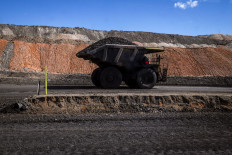 A coal hauler truck drives along a road with a load at the Moolarben coal mine, operated by Yancoal Australia, located in the western New South Wales coalfields and north of the town of Mudgee on September 3, 2026. Australia's coal mines are expanding as exports boom, awkward timing for a nation preparing to champion clean energy as lead negotiator for the UN's climate summit.