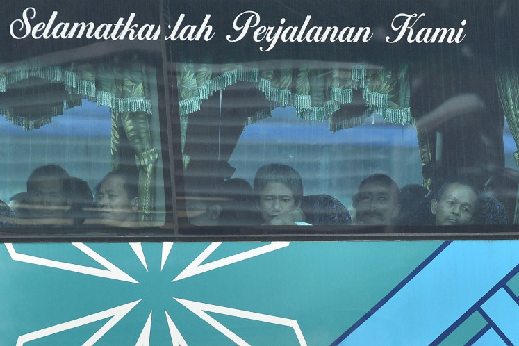 A bus carrying Myanmar nationals being repatriated from Malaysia to their homeland, is seen heading toward to navel base in Lumut, on the outskirts of Kuala Lumpur on Sept. 29, 2026. Malaysia began sending back around 1,500 Myanmar nationals on Sept. 29, AFP journalists saw, launching a scheme rights groups say may endanger migrants by returning them to the war-torn country.