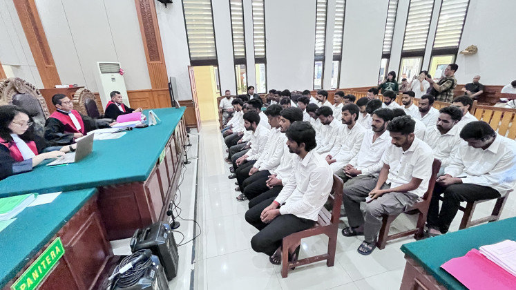 Thirty-five Indian nationals sit before judges on Oct. 7 at the Denpasar District Court during their verdict hearing in an online gambling case. They were sentenced to between two and two-and-a-half years in prison and will be deported and barred from re-entering Indonesia after serving their sentences.

