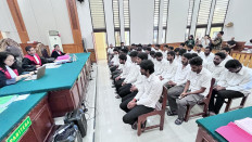 Thirty-five Indian nationals sit before judges on Oct. 7 at the Denpasar District Court during their verdict hearing in an online gambling case. They were sentenced to between two and two-and-a-half years in prison and will be deported and barred from re-entering Indonesia after serving their sentences.


