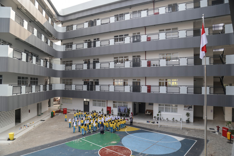 Students take part in a physical education activity outside state elementary school SDN Jati Pulo 07 and 08 in Palmerah, West Jakarta, on Thursday, Oct. 8, 2026. The Jakarta administration, through the Jakarta Education Agency, recently renovated the school buildings.