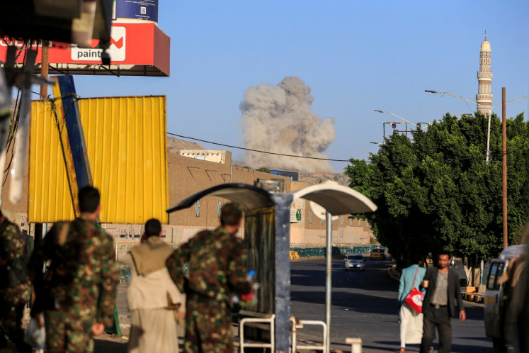A plume of smoke rises during a reported airstrike by the Saudi-led coalition on the Houthi-controlled Yemeni capital Sanaa, on October 9, 2026. The Houthis, who are fighting the Saudi-backed, internationally recognized government, seized the coastline alongside a crucial trade route during a lightning offensive last month, extending their control over all of Yemen's Red Sea coast.