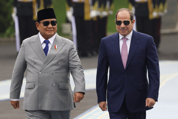Indonesian President&nbsp;Prabowo&nbsp;Subianto and Egyptian President Abdel Fattah al-Sisi walk on Sunday during a welcoming ceremony at the Merdeka Palace in Jakarta, Indonesia.