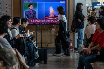 News coverage showing file footage of a North Korean missile launch is seen on a screen at Seoul Station in Seoul on October 12, 2026. North Korea on October 12 fired multiple ballistic missiles off its east coast, Seoul's military said, after weeks of mounting friction over a landmine explosion along the countries' heavily fortified border.