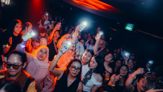 Put your hands up: Guests dance at an &ldquo;Over 30, 030&rdquo; session in Jakarta as the DJ spins nostalgic hits, particularly favorites among millennials, in this undated photo.