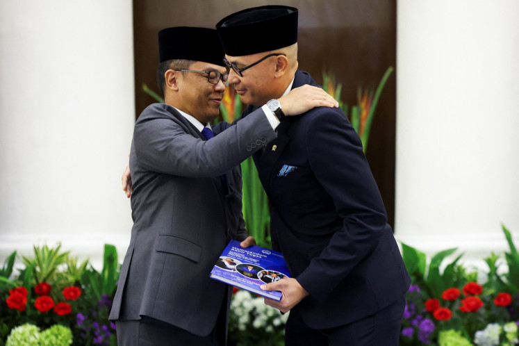 Newly appointed Foreign Minister Arrmanatha Nasir (right) reacts as former foreign minister and current Coordinating Minister for Human Development and Cultural Affairs, Sugiono, embraces him during a handover ceremony at the Foreign Ministry in Jakarta on Oct. 12, 2026.
