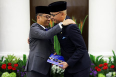 Newly appointed Foreign Minister Arrmanatha Nasir (right) reacts as former foreign minister and current Coordinating Minister for Human Development and Cultural Affairs, Sugiono, embraces him during a handover ceremony at the Foreign Ministry in Jakarta on Oct. 12, 2026.
