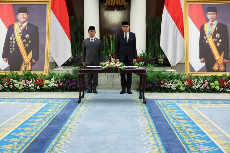 Indonesia's newly appointed Foreign Minister Arrmanatha Nasir (right) and former foreign minister and current Coordinating Minister for Human Development and Cultural Affairs Sugiono attend a handover ceremony on Oct. 12 in Jakarta.