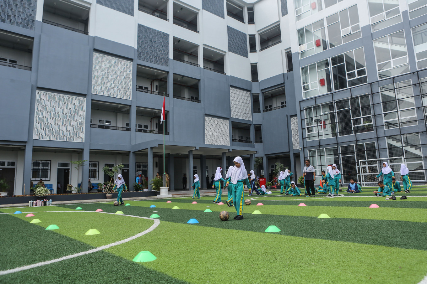 Students attend classes at state elementary school SD Pekayon 05 and state junior high school SMP 91 in Jakarta on Oct. 12, 2026. 